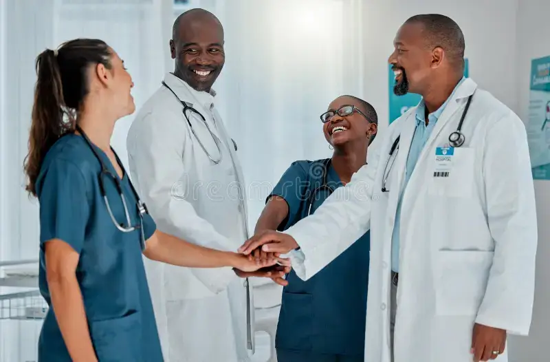 doctors huddle nurses hospital motivation support healthcare medical treatment happy pile hands smile man 346950810 (1)